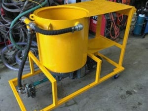 New yellow grout pump mixing bowl with Netzsch Progressive Cavity pump during fabrication