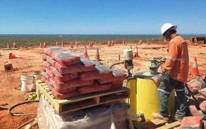 Construction worker using a hired poly mixing bowl grout pump