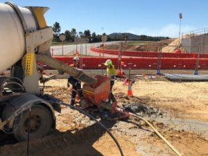 Contractors operating grout pump on-site as a part of a contracted project