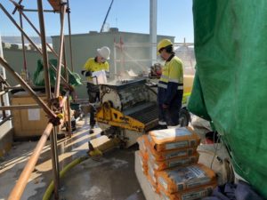 WA Grouting Systems contracting team members using a grout pump system on-site