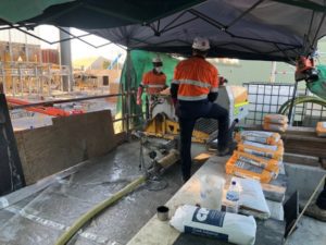 WA Grouting Systems contracting team members using a grout pump system on-site