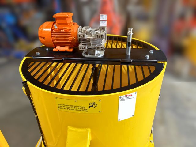 Electric motor and safety grate on a yellow 1000 litre poly paddle mixer