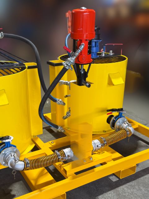 B150b air powered grout pump dual pump setup B150b air powered grout pump with twin pump units, hoses and yellow poly mixing bowls.